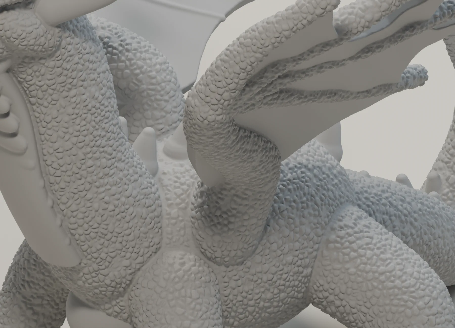 Neutral-grey close-up of the dragon STL showing scaled skin, a strong shoulder and curved wing structure.