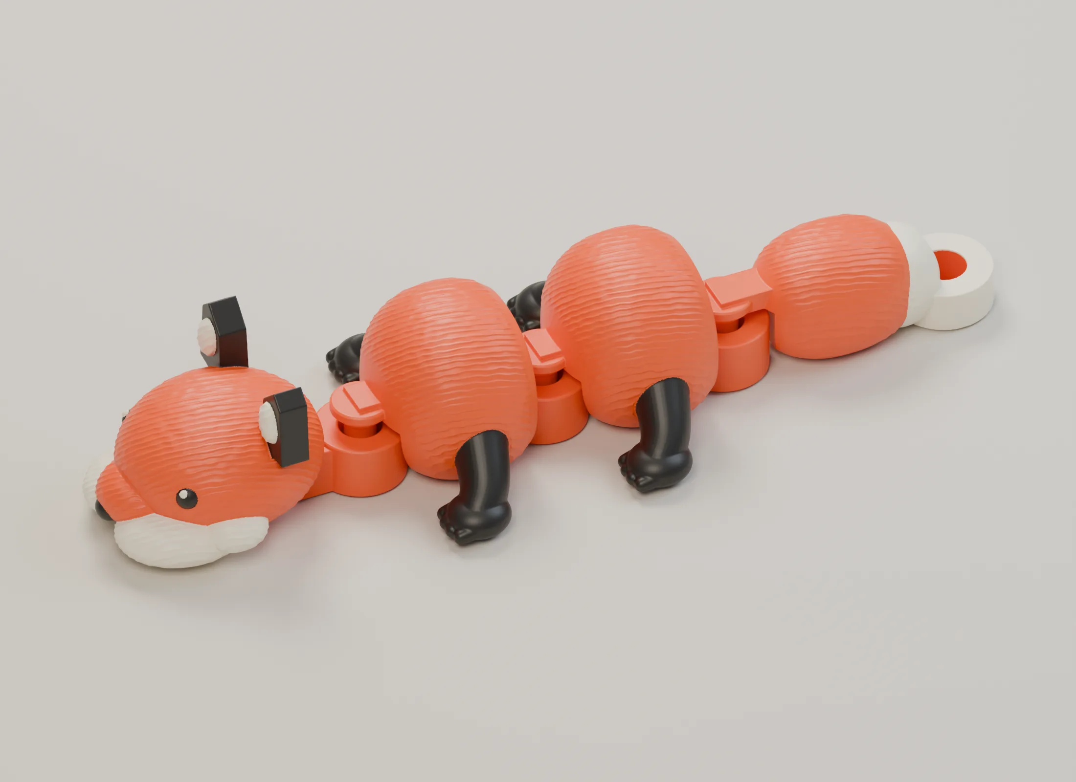 Compact orange, ivory and charcoal fox in its flat print pose, with a head, two separate body lobes, three captive hinges and a tail-mounted key-ring eye.
