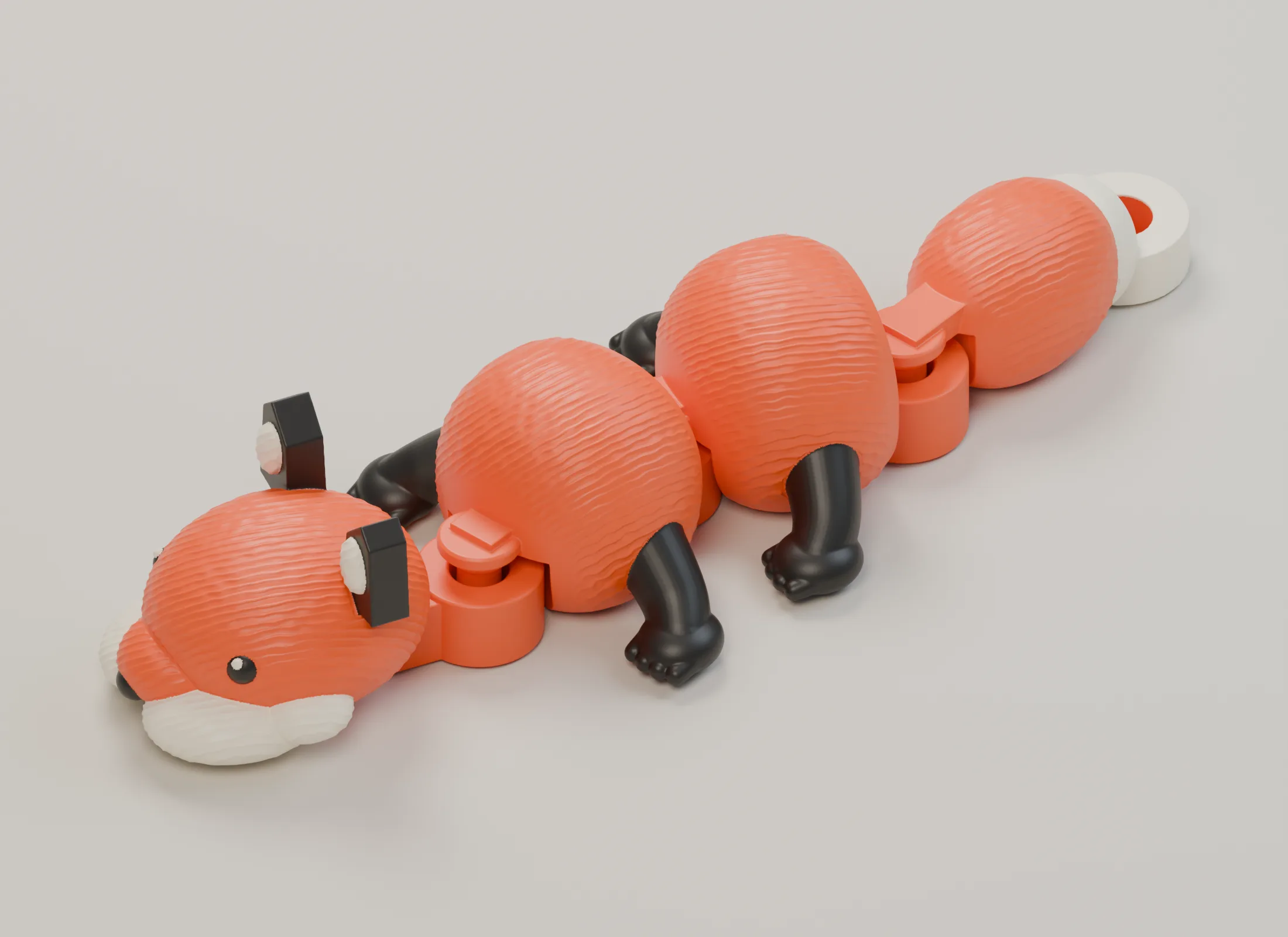 The compact articulated fox curved sideways at its three hinges, with four distinct captive sections and the attachment eye on its tail.